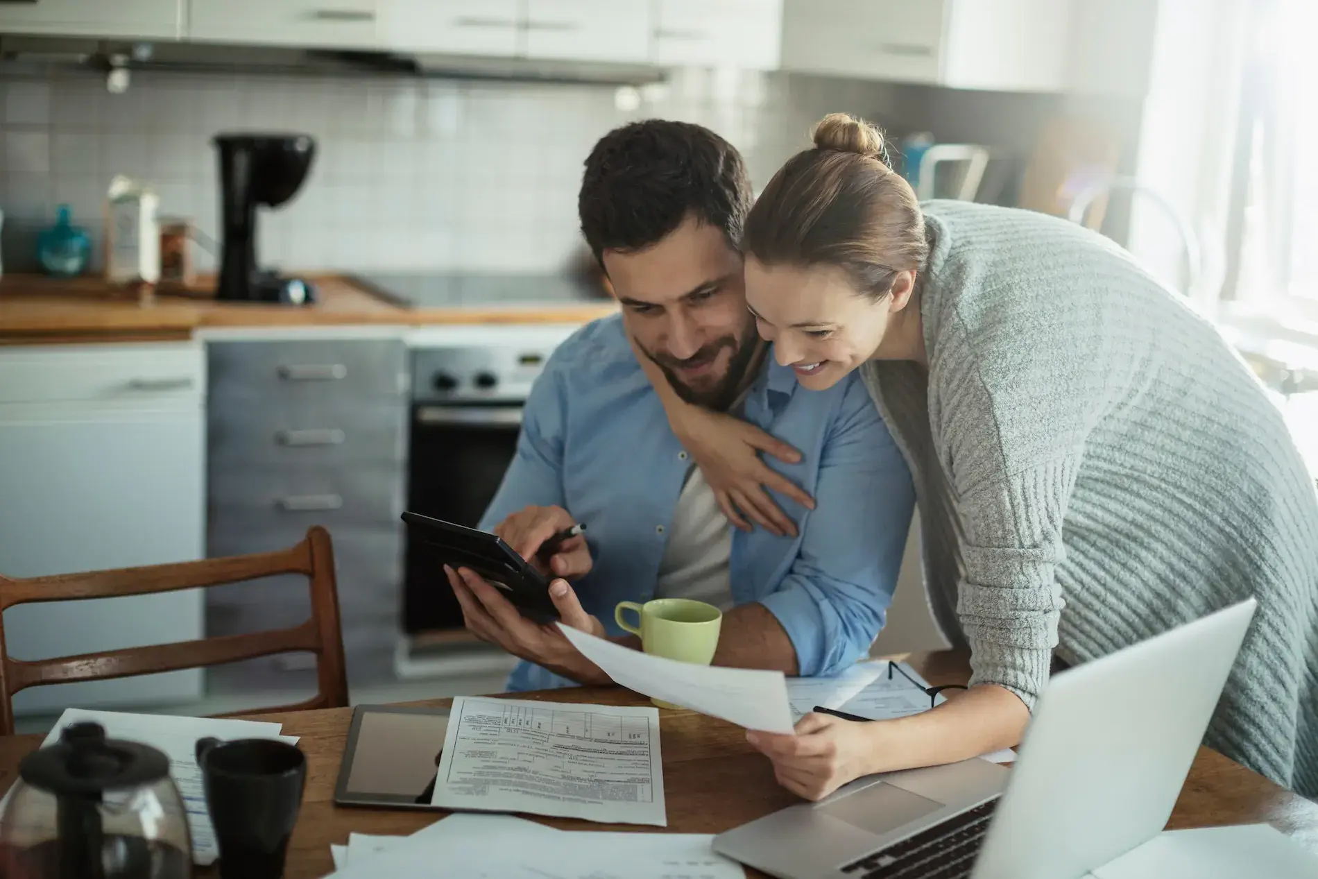 Happy young couple buying insurance paying bills online